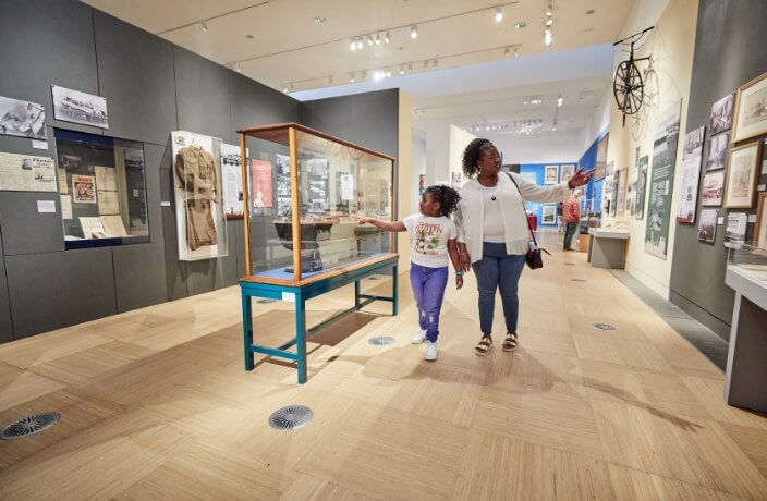 Woman and child walking through exhibit